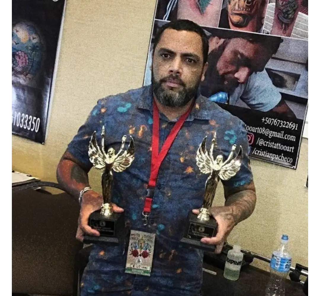 Expo Tattoo Music 2018 — 1st Place & Best Tattoo Cristian Pacheco holding two tattoo award trophies from Expo Tattoo Music 2018, Panama